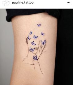 a woman's tattoo with blue butterflies on her stomach