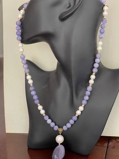 Exquisite Tanzanite & Purple Chalcedony Necklace with Pendant | Handcrafted Pearls - Nature-inspired Jewelry | Stunning Handcrafted Jewelry A very beautiful tanzanite, pearl and purple chalcedony necklace and pendant with brass fixtures Discover the enchanting allure of our Exquisite Tanzanite & Purple Chalcedony Necklace with Pendant, a masterpiece meticulously handcrafted to bring a touch of nature's elegance right to your neckline. Each necklace is a unique testament to the artistry and passion of our dedicated jewelers, ensuring that you receive a piece as individual as you are. Imagine draping your neck with a symphony of lustrous pearls and the serene hues of genuine tanzanite and purple chalcedony. The centerpiece of this exquisite creation is a pendant that captures the eye with it Taaffeite Necklace, Chalcedony Necklace, Purple Chalcedony, Tanzanite Necklace, Necklace With Pendant, Tanzanite Stone, Brass Fixtures, Bleu Violet, Purple Necklace