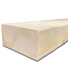 a large block of wood sitting on top of a white surface with no one around it