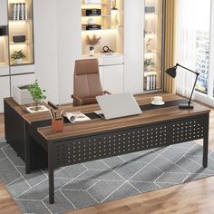 an office desk with a laptop on it in the middle of a living room area