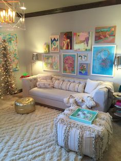 the living room is decorated for christmas with pictures on the wall and lights in the corner