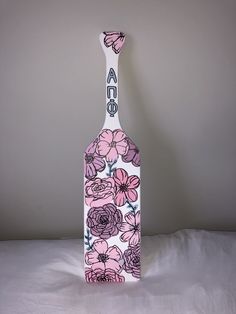 a wine bottle with flowers painted on it