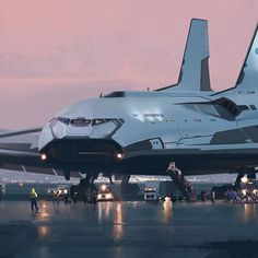 a large jetliner sitting on top of an airport tarmac at night with people around it