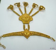 "20K GOLD BRACELET DORSAL HAND ORNAMENT (HATHPHUL; HATH HAKALU; PANCHANGALA), THAT INCLUDES, IN ADDITION TO THE USUAL ELEMENTS, ORNAMENTS FOR THE FINGER ENDS. Great design bracelet with 5 finger rings attached (hathful).Rings are attached with the middle piece by handmade chains. See similar sample in\" Traditional jewelry of India\" by Oppi Untracht. Size of the bracelet - 19.3 cm(7.6\") we can adjust the size. Ring sizes - Free size weight - 51.8 grams Material - 20k yellow gold." Ring Bracelet Chain Gold Indian, Traditional Ceremonial Festival Anklets, Traditional Gold Adjustable Anklets, Traditional Gold Anklets Adjustable, Traditional Gold Anklets With Adjustable Fit, Traditional Gold Anklets For Festivals, Traditional Bangle Anklets For Festive Occasion, Traditional Gold Bracelets For Festival, Traditional Gold Festival Bracelets