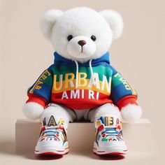 a white teddy bear wearing a colorful shirt and sneakers