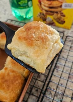 a piece of bread is being held by a spatula