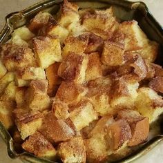 a pan filled with cinnamon rolls sitting on top of a counter