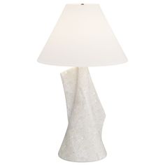 a table lamp with a white shade on it's base and a light bulb in the middle