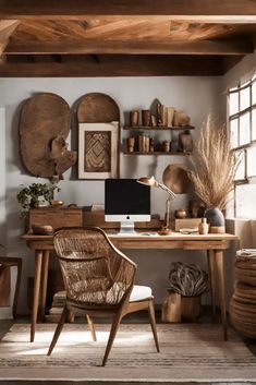 a desk with a computer on top of it next to a chair and potted plant