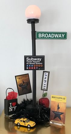 there is a lamp post with street signs on it and other items in front of it