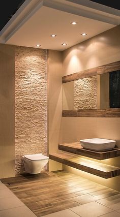 a modern bathroom with stone walls and flooring