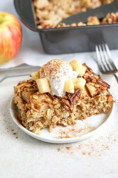 a white plate topped with food next to an apple pie