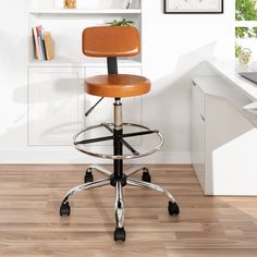 an office chair sits in front of a desk with bookshelves on the wall