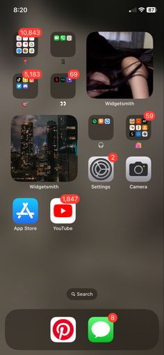 an iphone screen with several different icons on the phone and in front of it is a cityscape