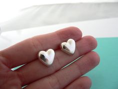 Some people wear their hearts on their sleeves ... I suggest you show off your shiny heart on your ears! :) Offered for sale is a wonderful pair of Tiffany and Co. Silver Puffed Heart earrings. The earrings are made from solid Tiffany silver, yet maintains a very feminine and delicate feel to it . These earrings look great with almost any attire one can think of - it can go from a day on the beach in shorts to a night out of town - no changing necessary. The style is classic Tiffany, and I am ce Mexico Earrings, Tiffany And Co Earrings, Sterling Silver Flower Earrings, Tiffany Earrings, Rare Gifts, Puffed Heart, Love Anniversary, Gift Love, Earrings Studs