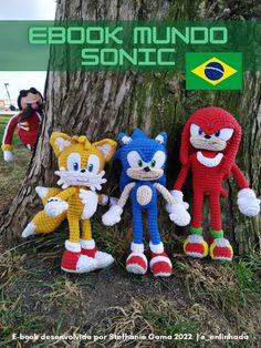 three crocheted sonic the hedgehogs are next to a tree