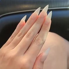 a woman's hands with long, pointed nails