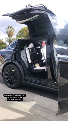 an electric car with its door open on the street