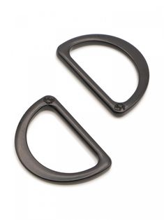 two black metal door handles on a white background, one is open and the other has an oval handle