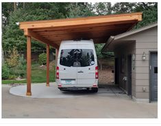 a white van parked under a wooden covered carport