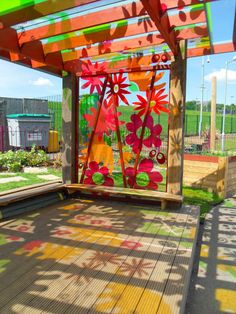 an outdoor covered area with flowers painted on it