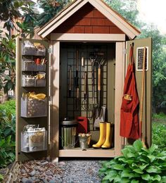 an outdoor storage shed with gardening tools in it