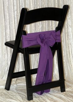 a chair with a purple sash tied to it