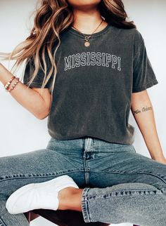 Mississippi Tee, College Style Tee, Mississippi State Souvenir. 100% Cotton, Authentic COMFORT COLORS T-Shirt, Premium Quality Fabric, Printed in the USA Direct on Garment Printing using Water Based Eco-friendly Inks. Unisex Sizing, Relaxed Fit For Women.  Go 1-2 sizes up for the oversized look On White and Ivory colors we print black text. You can compare one of your tees to the sizing chart available in our listing photos. Colors might be look a bit different on different screens, the design i Soft-washed Cotton T-shirt For Fan Apparel, Soft-washed Cotton T-shirt For Fans, Relaxed Fit Screen Print Tops For College, College Style Short Sleeve Screen Print T-shirt, College Style Short Sleeve T-shirt With Screen Print, Crew Neck Top With Screen Print For College, Screen Printed Crew Neck Tops, College Style Crew Neck Top With Screen Print, Casual College Shirt With Screen Print