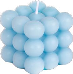 a candle that is shaped like a bunch of blue balls with a white stick sticking out of it