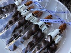 several chocolate candies wrapped in cellophane on a plate