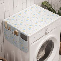 a white washer sitting next to a tiled wall