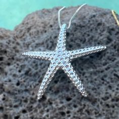 Catch a shooting star with our "Hoku" Starfish Pendant - crafted in .925 Sterling Silver or Gold Plated. Textured to mimic the look of a real starfish, it sparkles when it moves with you. Clever bale design is integrated into the pendant. This special is an 18 inch adjustable chain. "Hoku" Starfish Pendant Textured to mimic the look of a real starfish Clever bale design integrated into pendant Available in .925 Sterling Silver or Gold Plated Special matching 18 inch adjustable chain. Starfish Shaped Jewelry With Star Charm As Gift, Ocean-inspired Star Charm Jewelry, Sterling Silver Starfish Charm Jewelry, Ocean-inspired Silver Star Jewelry, Ocean-inspired Star Shaped Silver Jewelry, Silver Starfish Charm Jewelry, Silver Starfish-shaped Jewelry Gift, Silver Starfish Jewelry For Gifting, Silver Starfish Jewelry For Gifts