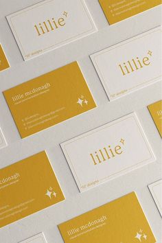 many business cards are stacked on top of each other in yellow and white colors, with the name lillie written across them