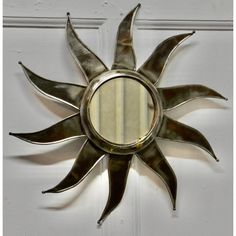 a sun shaped mirror mounted to the side of a door