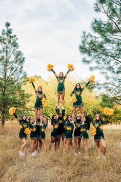 a group of cheerleaders standing in a field