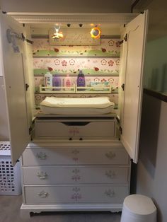 a baby changing table and dresser in a room