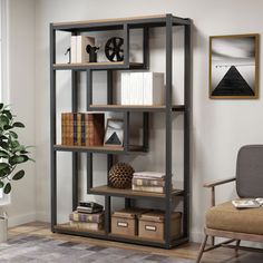 a room with a chair, bookshelf and pictures on the wall