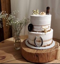 a three tiered cake sitting on top of a wooden table