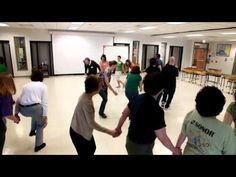 a group of people dancing in a large room