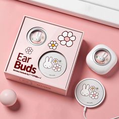 an ear buds box with bunny ears and flowers on the side, next to it