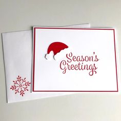 two christmas cards with the words season's greetings written in red and white