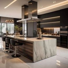 a modern kitchen with marble counter tops and black chairs