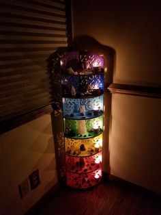 a multi - colored shelf is lit up in the dark