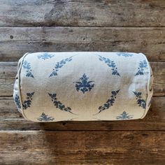 a roll of toilet paper sitting on top of a wooden floor