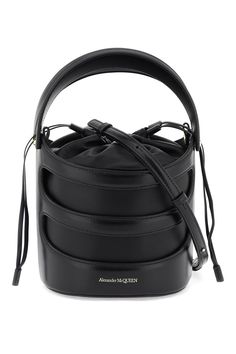 The Rise bucket bag by Alexander McQueen is made of leather with a structured Harness-style cage and a soft nappa pouch. It features a drawstring closure, a leather interior, and an adjustable and removable shoulder strap. The metallic accessories have a gold finish. Metallic Accessories, Alexander Mcqueen Bag, Winter Bags, Woman Bags Handbags, Metal Accessories, Leather Bucket Bag, Leather Bucket, Leather Interior, Bag Sale