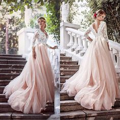 a woman in a pink dress standing on some steps