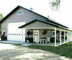 a barn with a covered porch and picnic table