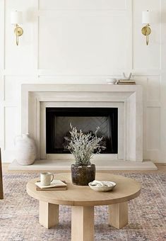 a living room with a fire place and coffee table