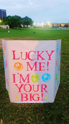 a large sign that says lucky me i'm not your big hug on the grass