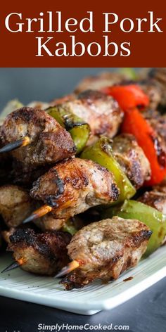 grilled pork kabobs on a plate with peppers